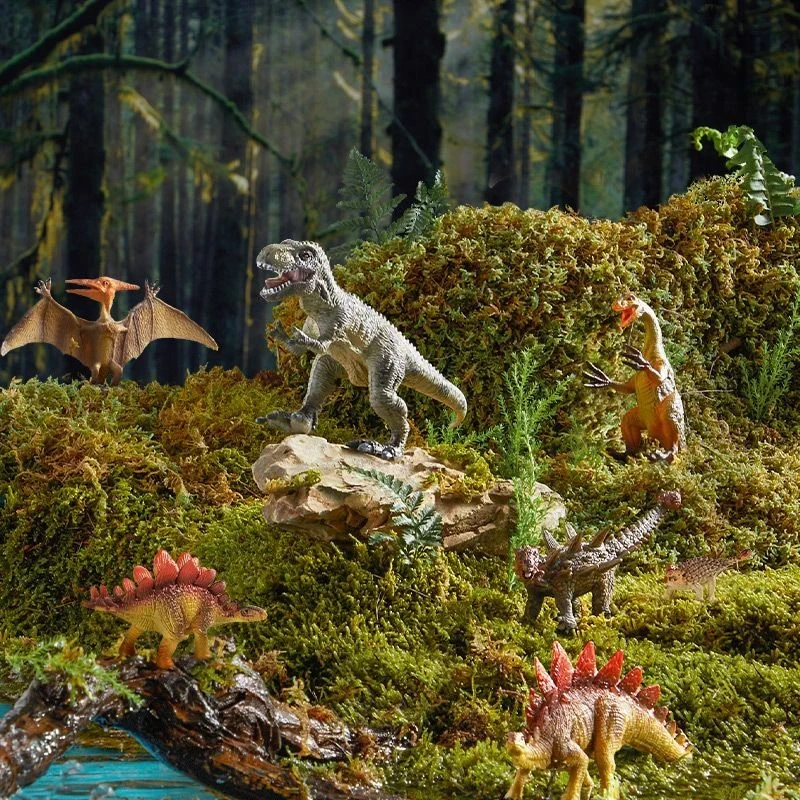 Dziecko bawiące się figurkami dinozaurów Mideer