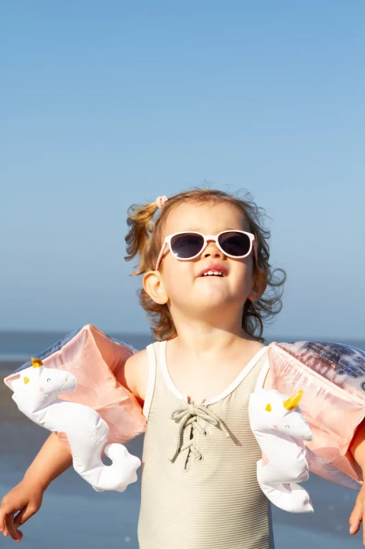 Dziecko w różowych okularach Ki ET LA WaZZ na plaży